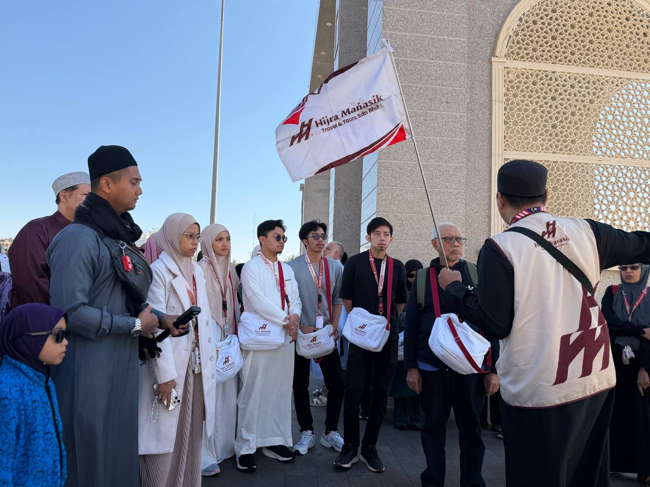 Kumpulan jemaah Hijra Manasik bersama bendera rasmi